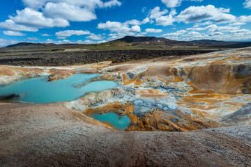 Beautiful colourful Icelandic landscape lava fields mountain geysers zigzag road and moss-covered...