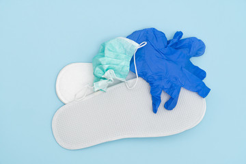 white slippers, used surgical mask and silicone gloves, as a concept of death from a virus or...