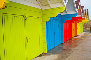 Row of colorful closed beach huts in seaside resort