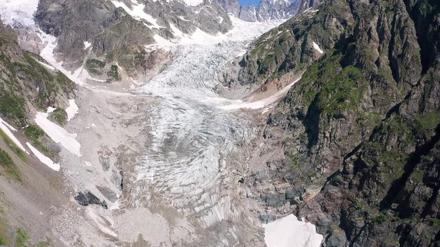 Caucasus Mountains on the border of Russia and Georgia. Chalaat Pass and Very beautiful view of the Chalaadi Glacier, Mount Ushba and Mestiachala river with background of clear blue sky.