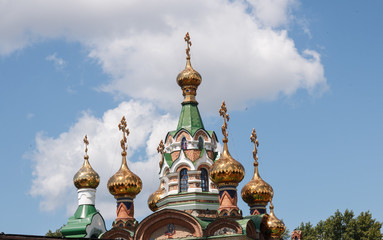 Fototapeta na wymiar Golden domes and crosses of the Christian Church against the blue sky
