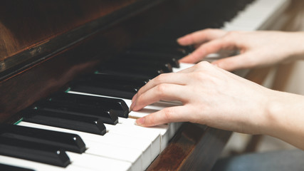 Girl is playing the piano. Music creating. Hobby on the quarantine time. Learn new things.