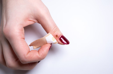 Marks from laser removal of wart. Contagious skin illness on woman's hand. Removing plaster from finger. Medical treatment photo.