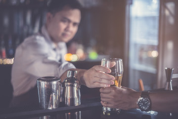 Bartenders mix drinks and serve them to customers