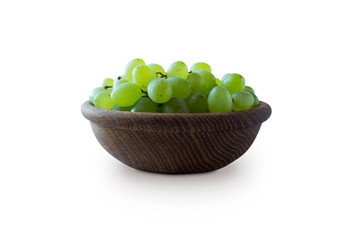 Green grapes Kishmish isolated on white background. Top view. Grapes in a wooden bowl isolated on white background. Vegetarian or healthy eating.Top view.Green grapes Kishmish with copy space for text
