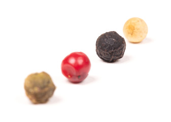 Peper background, white, green, black and red, selective focus on the black peper