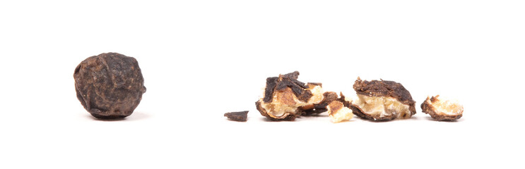 Whole peper next to a crushed one - Black