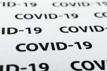 Black plain text on white paper about coronavirus outbreak. Covid-19.