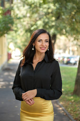 close portrait of attractive business woman in black shirt utdoors