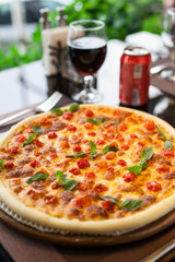 An Italian margarita pizza with coca cola