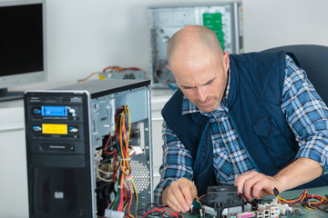 portrait of technician repairing a computer