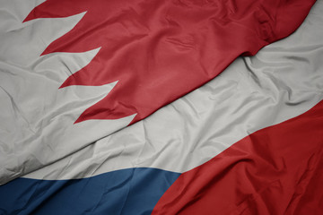 waving colorful flag of czech republic and national flag of bahrain.