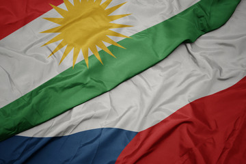 Obraz premium waving colorful flag of czech republic and national flag of kurdistan.