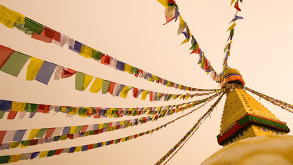A artistic view of the upper part of the Swayambhu Stupa with prayer flags, Kathmandu Nepal