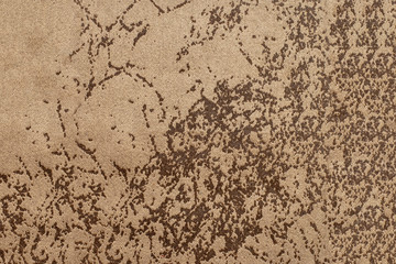 Texture of light brown suede fabric with a pattern. Background, blank