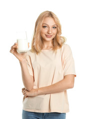 Beautiful young woman with milk on white background