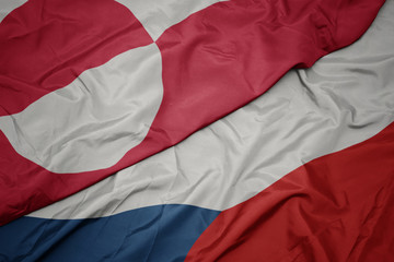 waving colorful flag of czech republic and national flag of greenland.