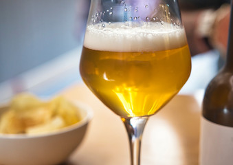 A glass of beer on the table on a terrace in Italy, focus on glass of beer