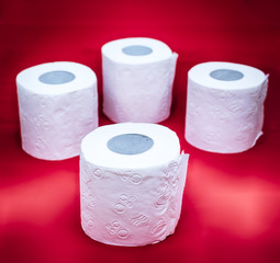 rolls of toilet paper on a red background