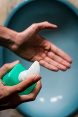 Young man using hand sanitizer