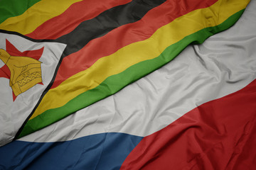 waving colorful flag of czech republic and national flag of zimbabwe.