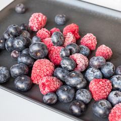 wildberies, raspberries and blackberries on black plate