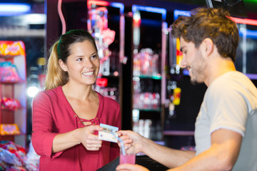 bartender accepting a credit card at bar counter in bar