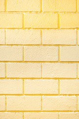 surface of a yellow brick wall. background image