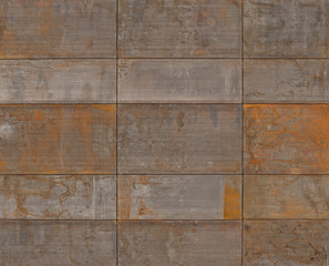 Rusty metal plates cover a modern facade of a building in an exciting way.