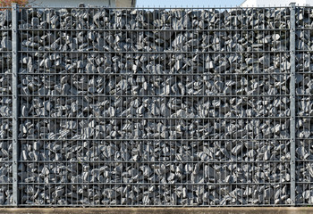 Wire fence filled with stones create a wall of Gabionen.