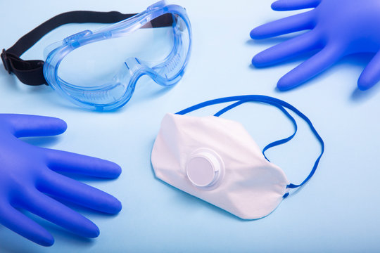 Coronavirus personal protective equipment (PPE)  concept. Medical latex gloves, protective goggles and ffp2 respirator.