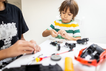 Kids building robot at robotic technology school lesson