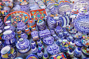 Colorful traditional Mexican pottery. Talavera style. Souvenirs on sale in local market of Puebla, Mexico.