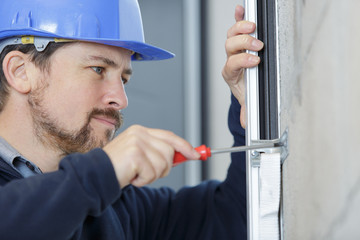 close view of handyman using a screwdriver