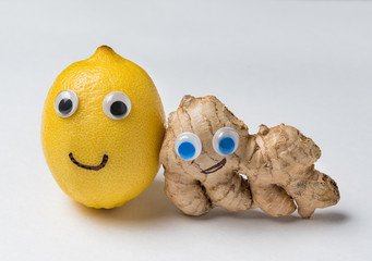 Lemon and ginger with Googly eyes on white background. Health products