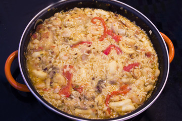 Rice paella cooked with chicken, seafood and vegetables