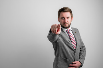 Portrait of business man wearing business clothes pointing camera