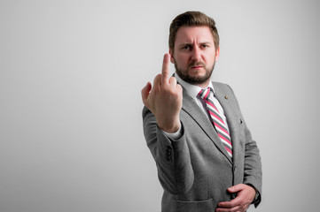 Portrait of business man wearing business clothes showing obscene gesture