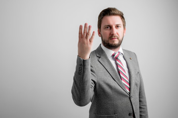 Portrait of business man wearing business clothes showing number four