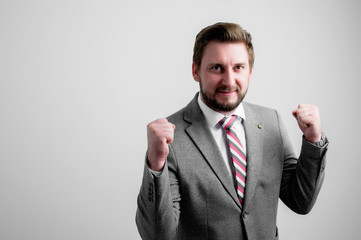Portrait of business man wearing business clothes making winner gesture