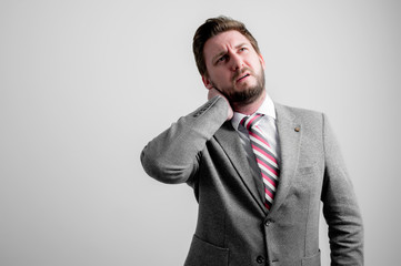 Portrait of business man wearing business clothes gesturing neck ache