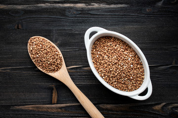 cereal raw fried buckwheat grains in white bowls - flat lay