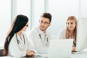 group of medical experts discussing online information.