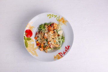 Caesar salad with chicken salad leaves on a light background, menu