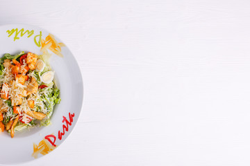 Caesar salad with chicken salad leaves on a light background, menu