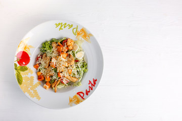 Caesar salad with chicken salad leaves on a light background, menu