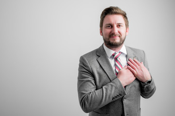 Portrait of business man wearing business clothes keep hands near heart