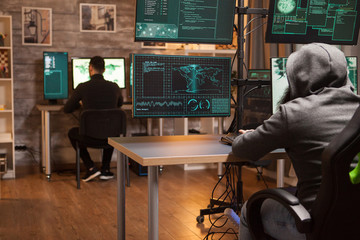 Back view of two hacker working together