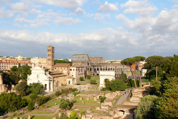 Fototapeta na wymiar Aerial panoramic cityscape view of the Roman Forum and Roman Colosseum during sunset in Rome, Italy