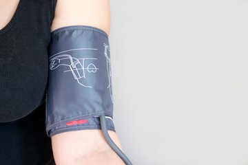 The device for independent measurement of blood pressure. Health in quarantine. Home tonometer. Close up. Hand with tonometer.